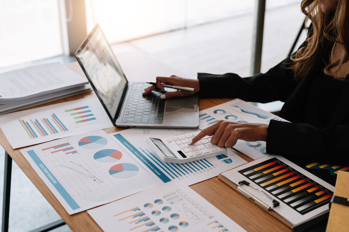 Economic udate woman sorting finances https://www.canva.com/photos/MAFFQjiR-qk/