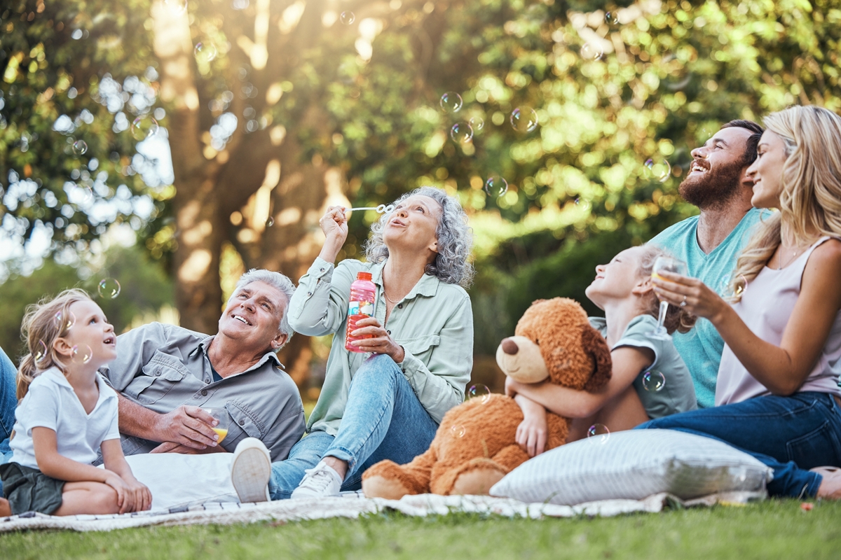 Happy big family, park picnic and love bonding, happiness and joy for reunion together smile in outdoor nature. Elderly Grandparents, mother and dad playing outside with excited girl children or kids Happy big family, park picnic and love bonding, happiness and joy for reunion together smile in outdoor nature. Elderly Grandparents, mother and dad playing outside with excited girl children or kids